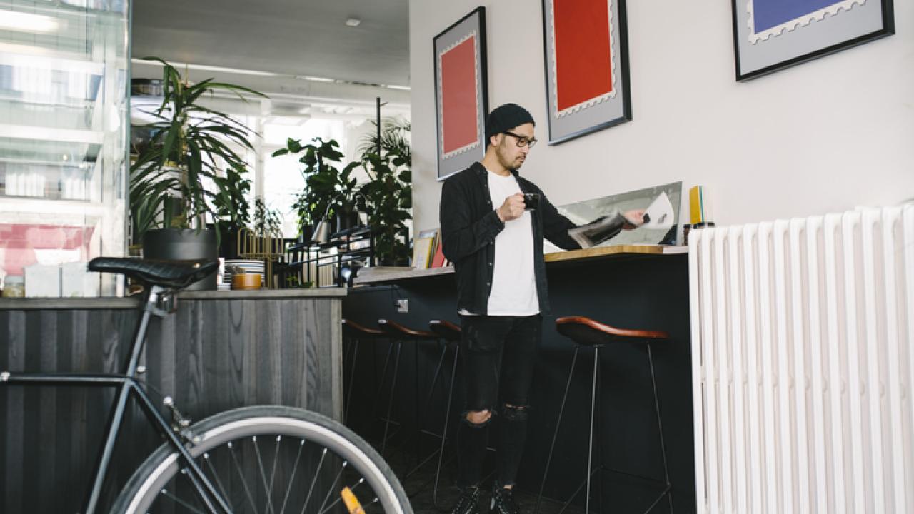 Office worker with bike and newspaper