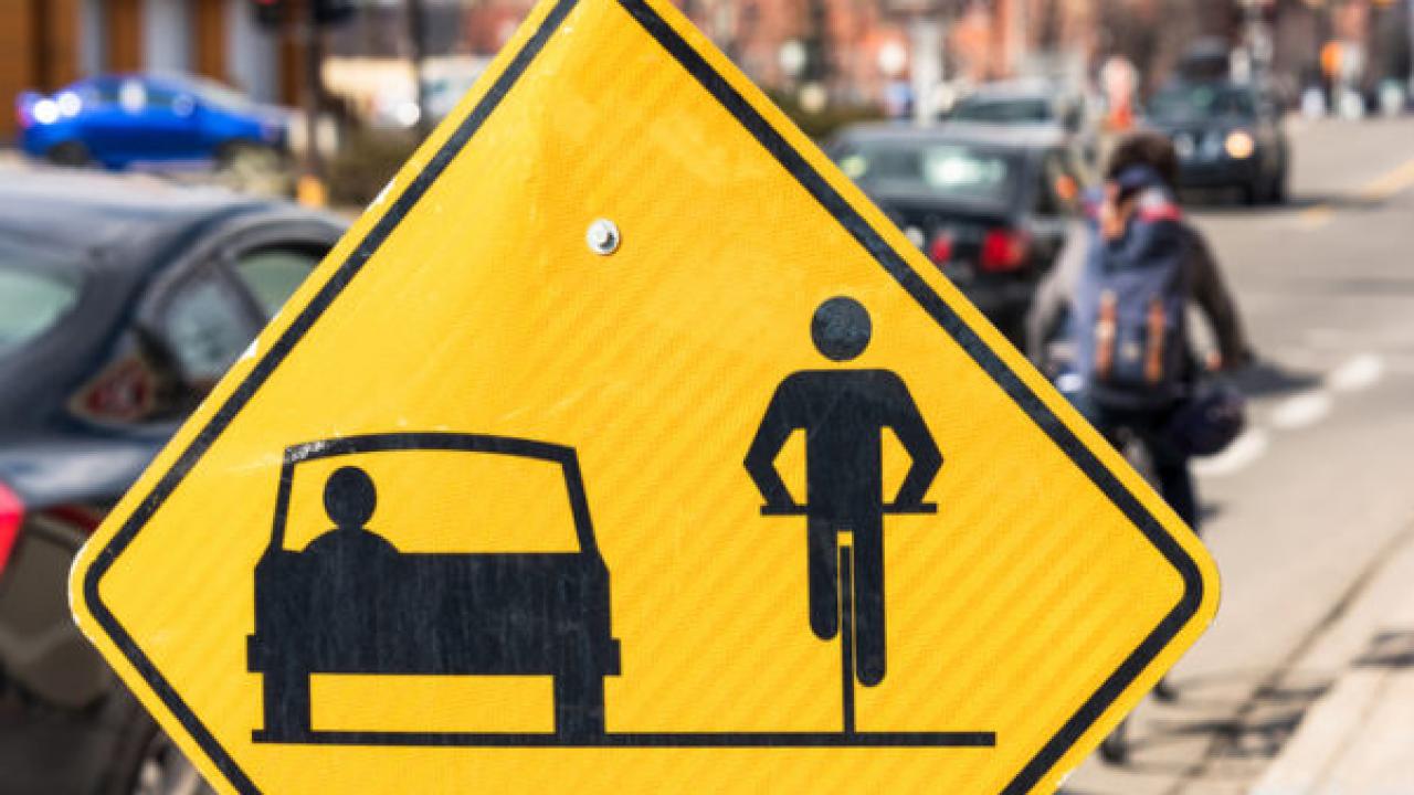 Sign urging drivers and cyclists to share the road