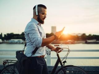 Commuter Listening to Music and Walking Bike